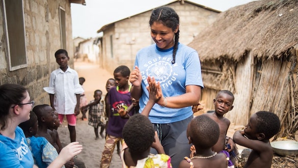 Student with children in Ghana