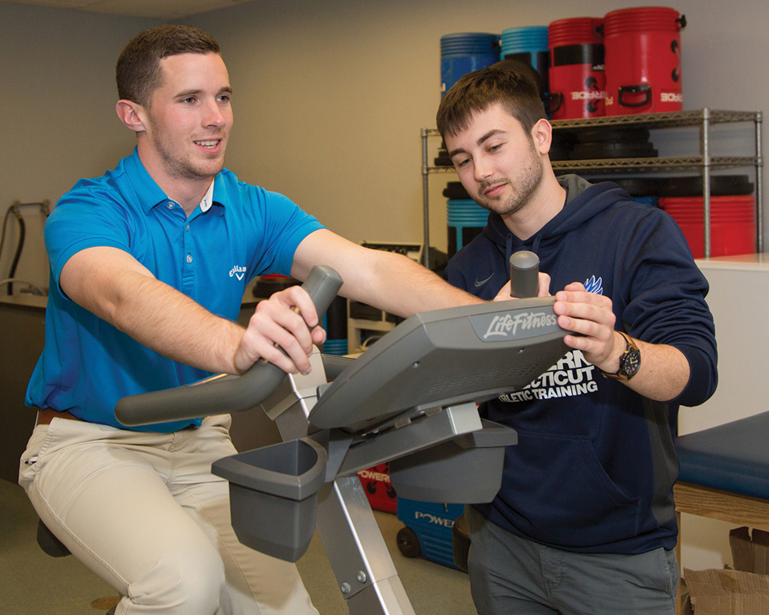 Two students, one on cycling while the other observes and records