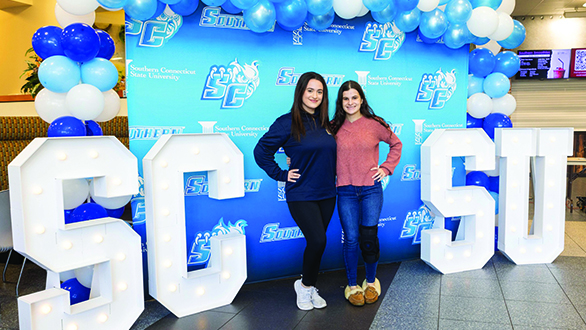 Two students with the Southern sign in lights