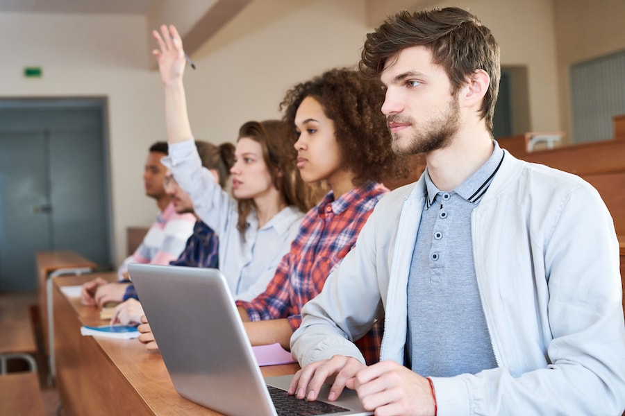 A group of college students in a seminar classroom setting