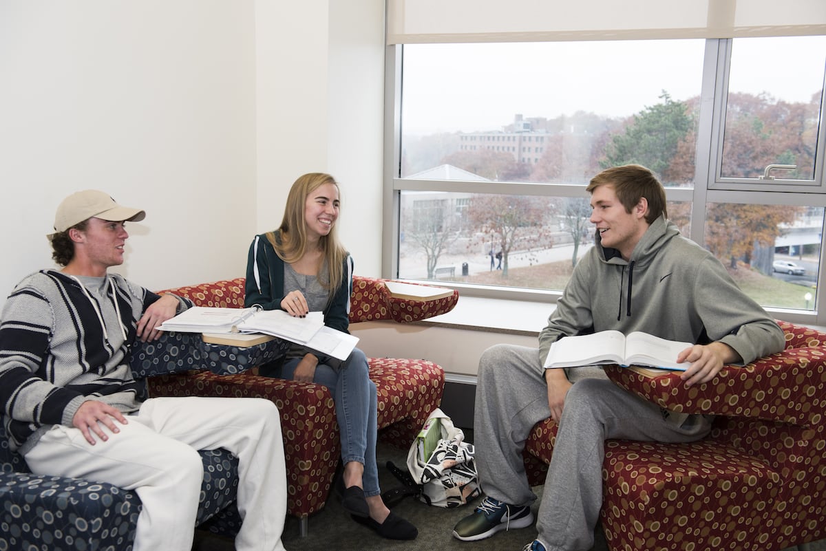 3 students sitting and chatting