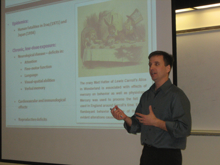 scientist presenting with a powerpoint slide presentaiton