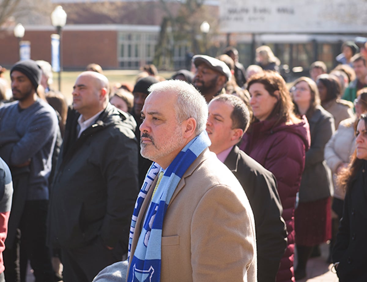 Joe listening in a crowd