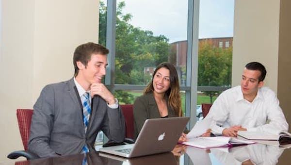 "Three professionals working in an office"