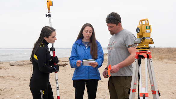Marine science students at the beach conducting research