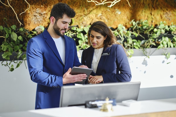 "Two hotel concierge at the hotel front desk"