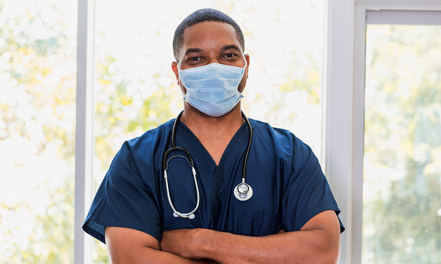 "Male nurse with a mask. scrubs and stethoscope"