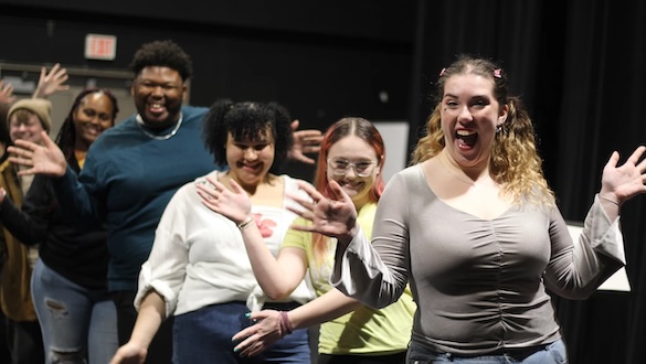 multiple actors in a line shaking their hands