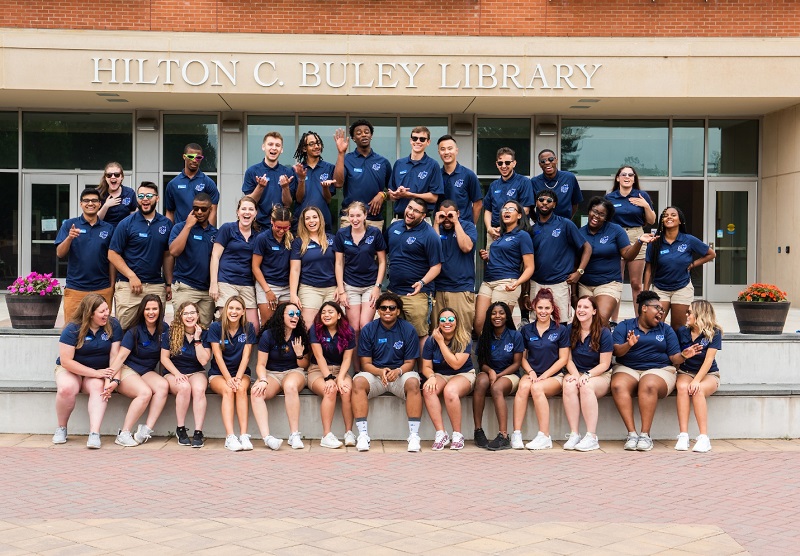 Orientation ambassadors in a group photo in front of university library