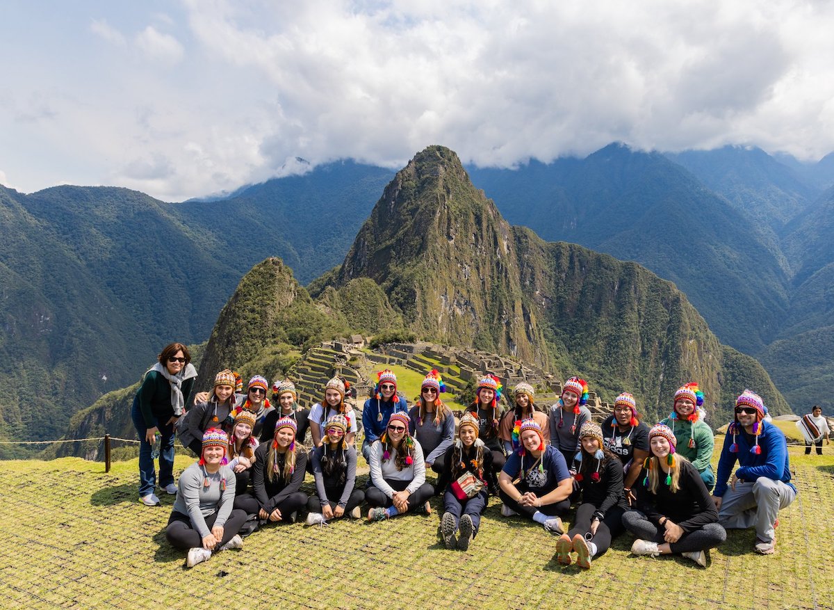 Students at Peru with mountains in the background