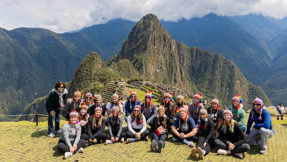 Students at Peru with mountains in the background