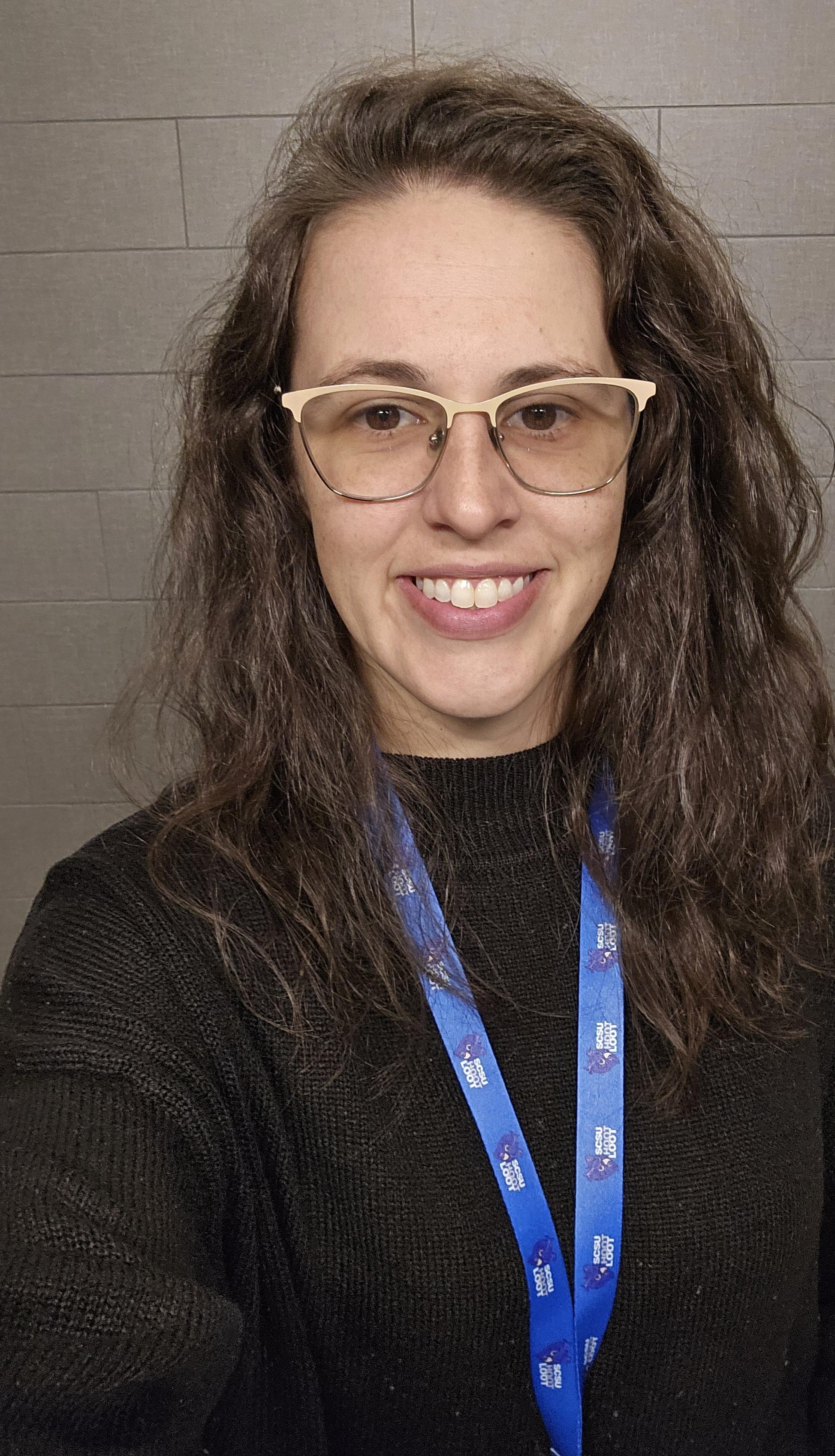 white woman with long brown hair and glasses