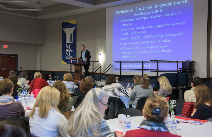 A person presenting in front of an audience