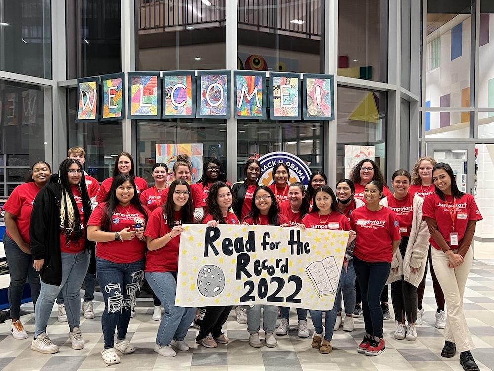 A lrage group of students holding a sign for 'Read for the Record 2022'