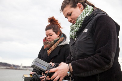 Two scientist collecting data with measuring devices