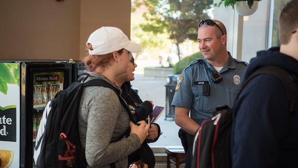 Police officer conversing with students