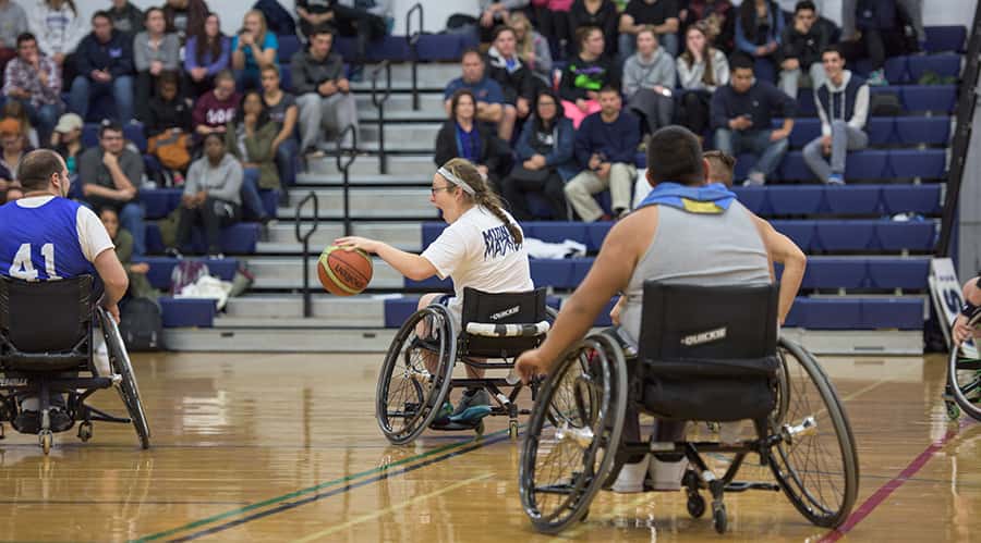 several people play basketball in wheelchairs