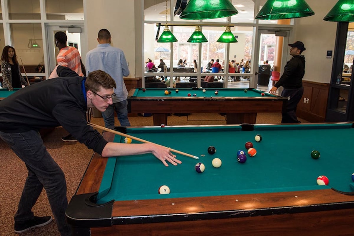 Student using the pool table