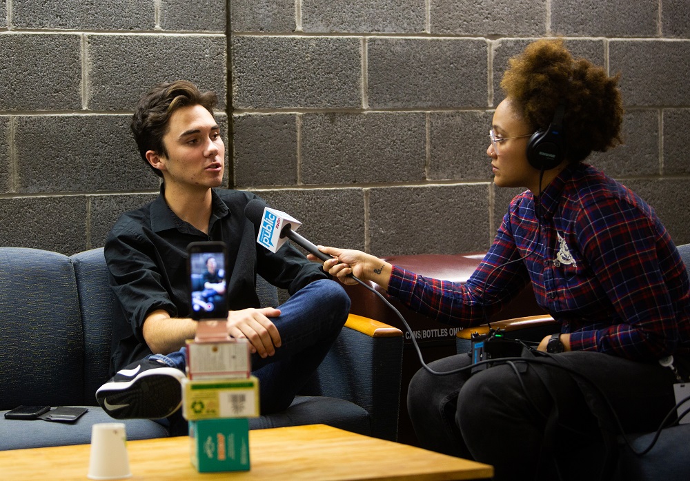 Student being interviewed by a journalism student