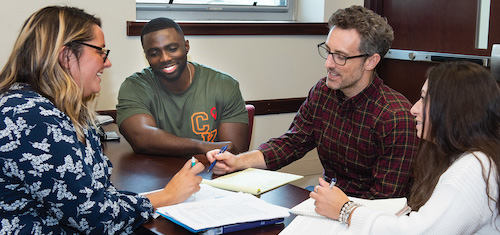 Four people working together at a table