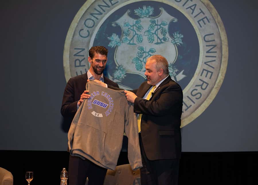 President Joe Bertolino presents Michael Phelps with a Southern sweatshirt