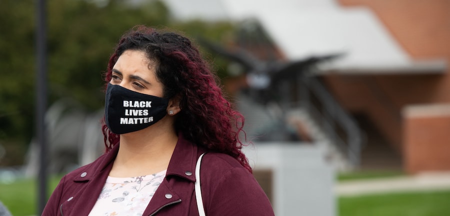 A student wearing a face mask with the writing of 'Black Lives Matter'