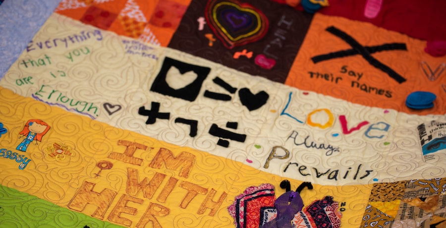 A quilt with a mosaic of social justice art