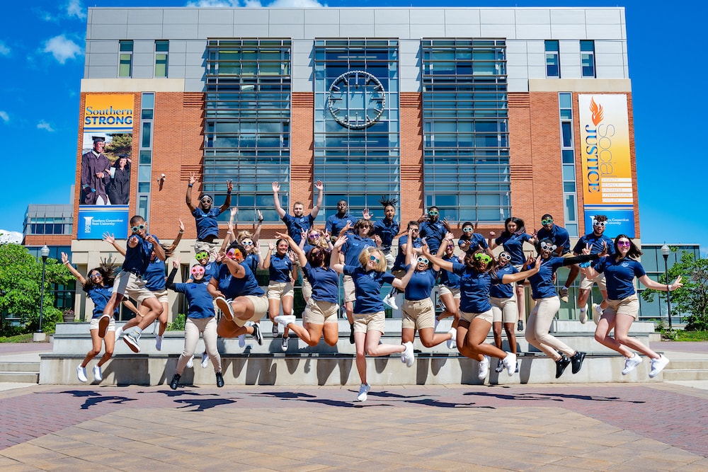 Orientation ambassadors in a group photo in front of university library