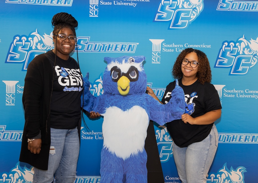 Two students with an Owl mascot stand
