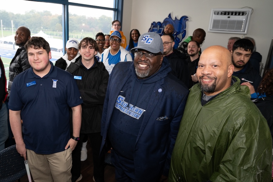 Dr. Dwane Smith with others at the President's box during a football game