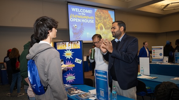 Student getting department information at an undergraduate open house event