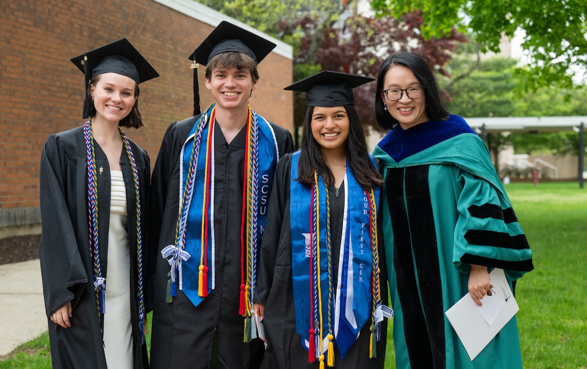 Students and professor at senior honors convocation
