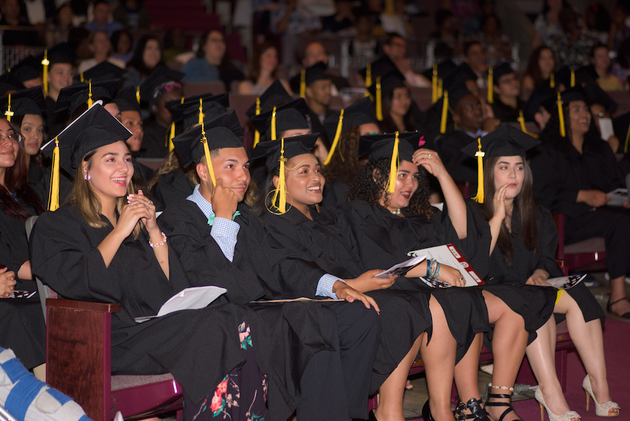 Students in a graduation ceremony with their caps and gowns