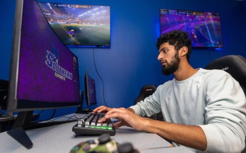 "A student playing a video game at the student center"