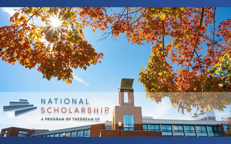 a shot of the Engleman Hall owl frame by autumn leaves on tree branches, with the words "National Scholarship: A Program of TheDreamUS" superimposed on the photo