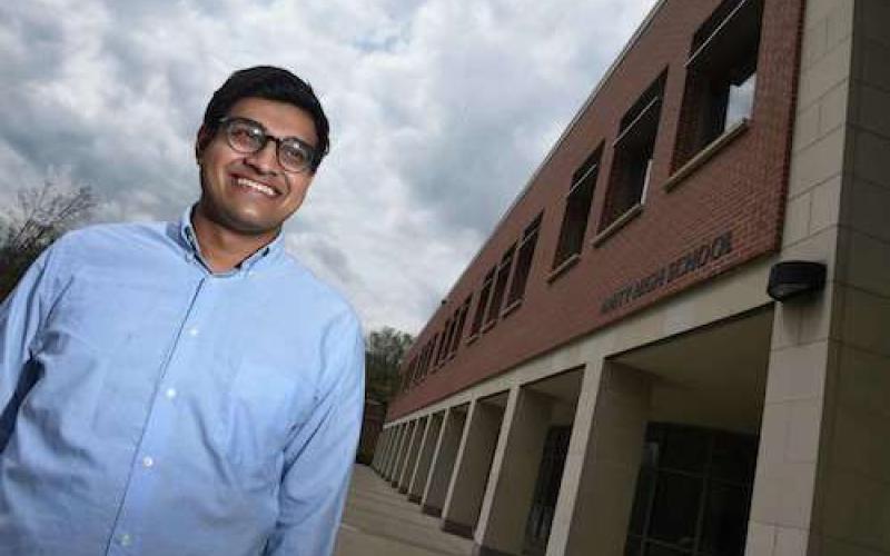 "A student next to an academic building"