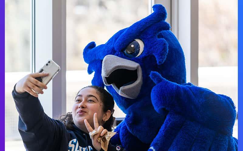 Otus the Owl and a student share a selfie