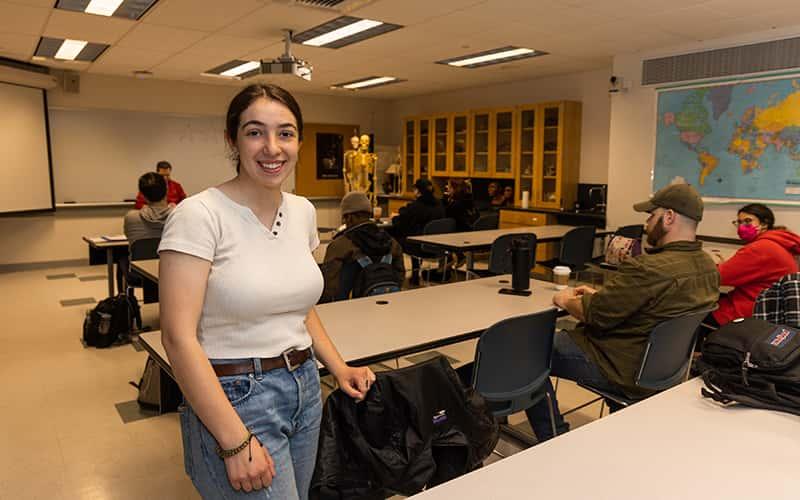 Lila Kleppner, a 2023 graduate of Wilbur Cross High School in New Haven, stands in a classroom at Southern