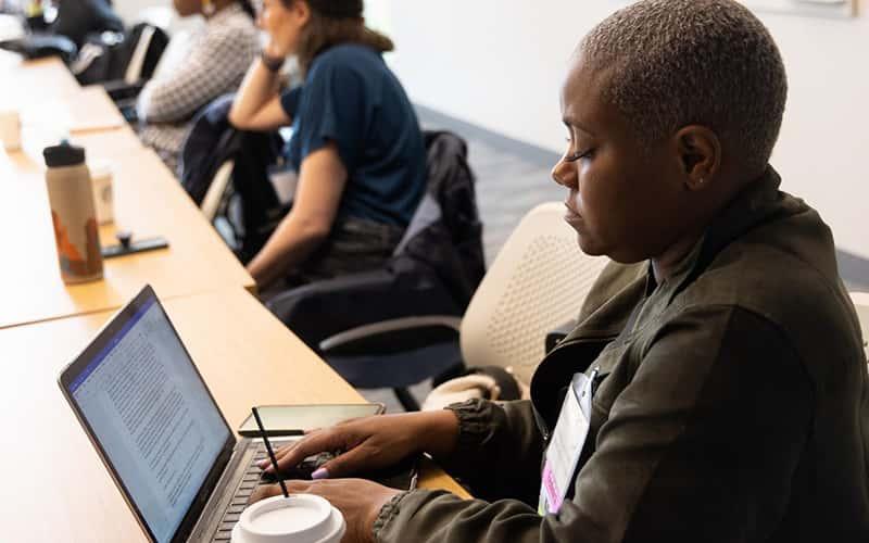 History Professor Siobhan Carter-David writes on a laptop