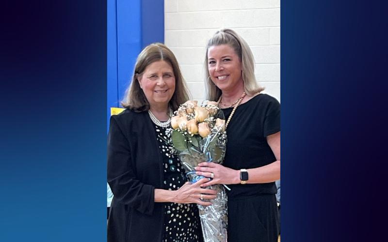 Seymour, Conn., Superintendent of Schools Susan Compton presents flowers to the district's 2025 Educator of the Year, Jessica DeNigris, M.S. '06