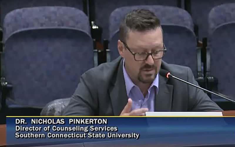 Dr. Nick Pinkerton, associate dean of counseling services and wellbeing at Southern Connecticut State University, testifies before the Connecticut Public Health Committee during a legislative roundtable hosted by State Senator Saud Anwar. 