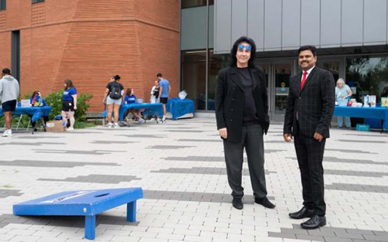 Dean Jess Boronico and Birasnav Mutharaj standing in front of the school of business