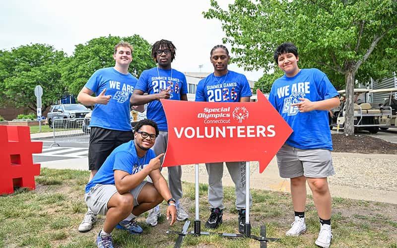 Five Southern students stand by a sign that says "Special Olympics Connecticut volunteers"
