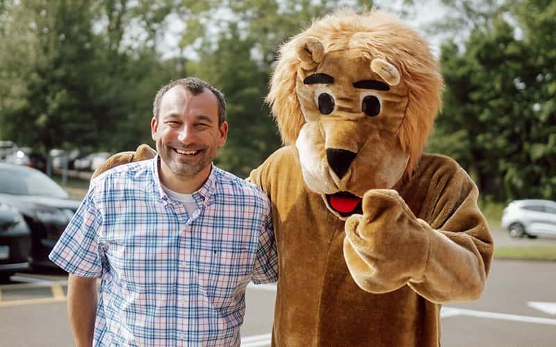 Award-winning principal Joseph Apicella, 6th Yr. '10, and the Orange Avenue Elementary School lion mascot