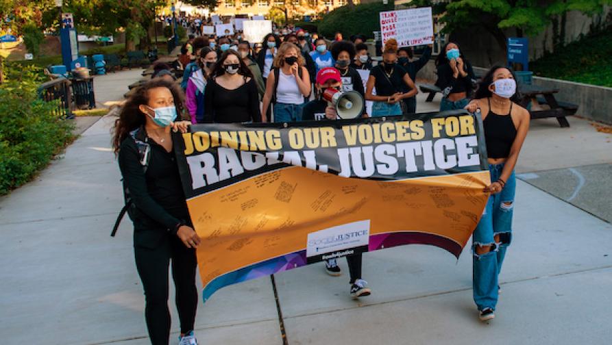 Students walking with sign