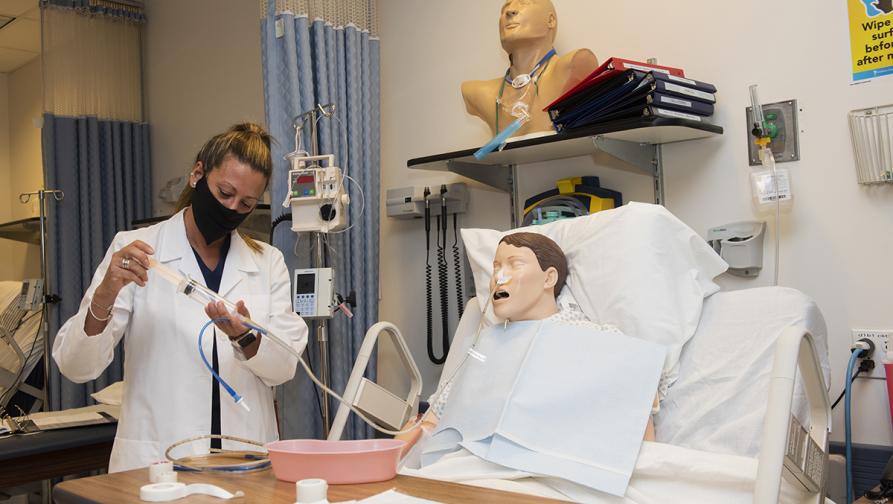 "A nursing student in a nursing simulation lab"
