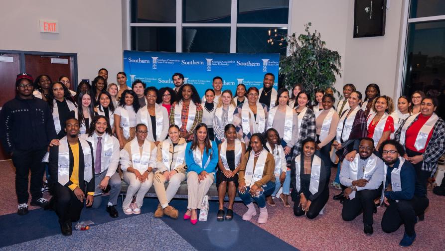 A group photo of students with their UAP Graduation Sashes and staff.