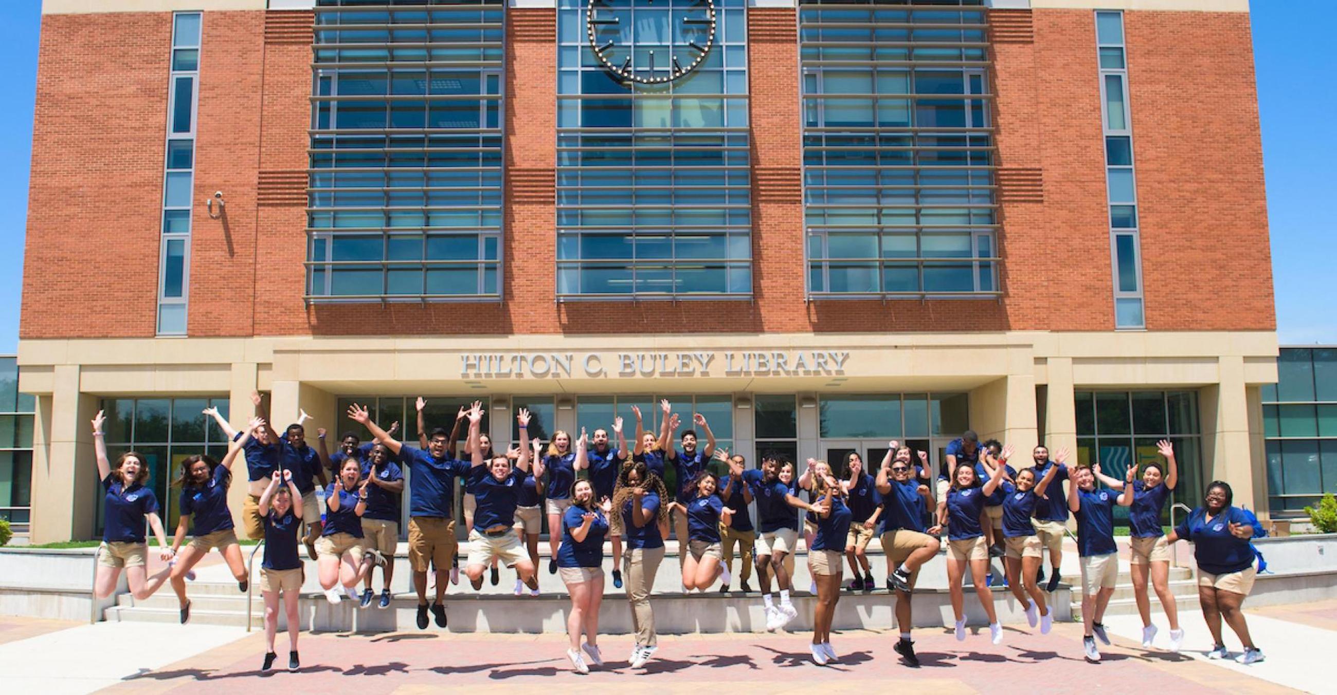 Orientation ambassadors outside in front of the library