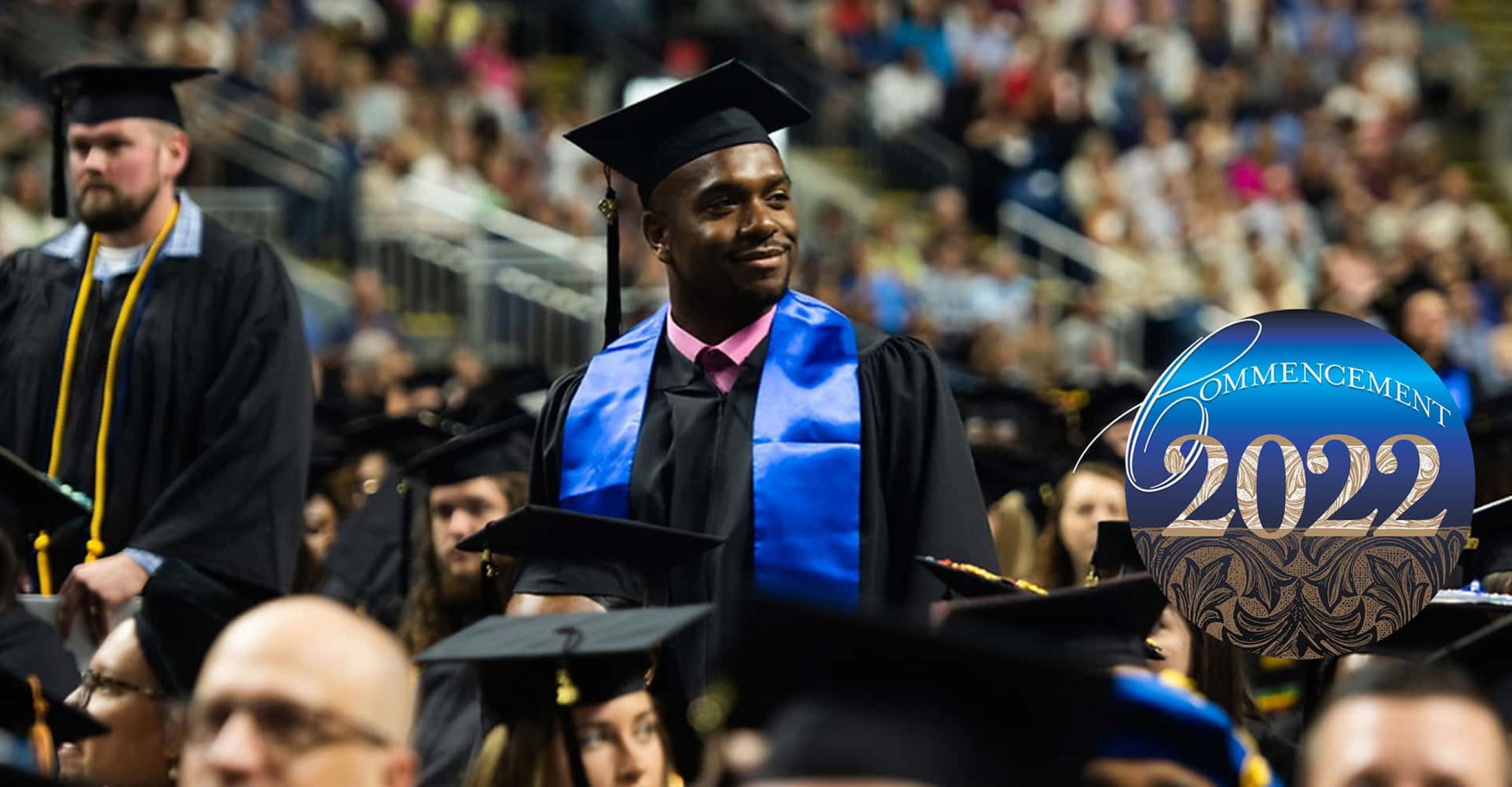 a male student in his cap and gown at commencement