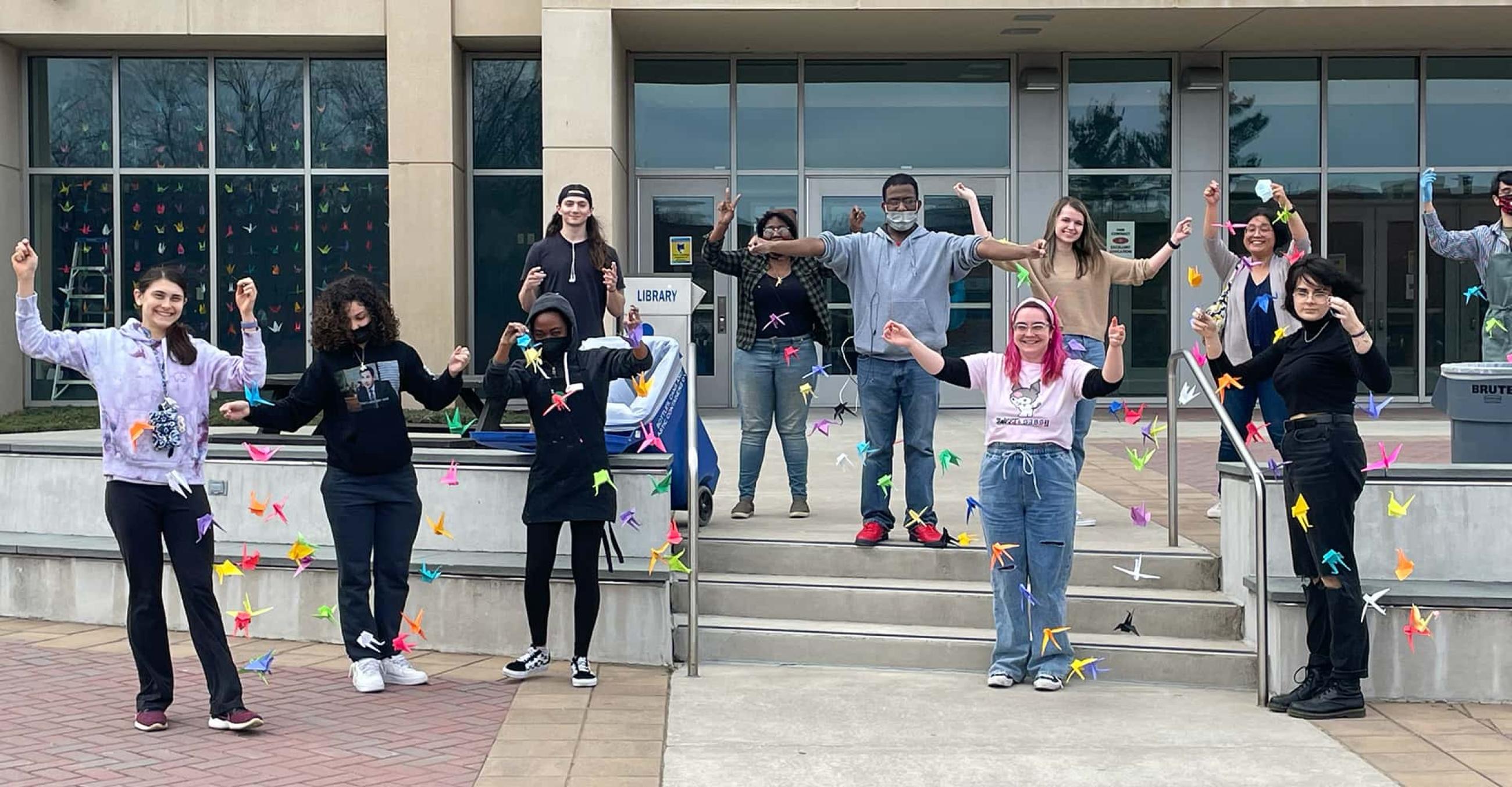 students outside Buley Library holding paper cranes